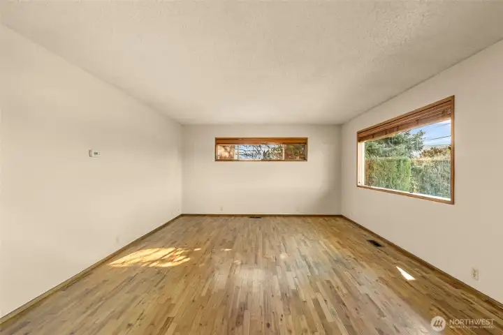Bright sunny windows in generous living room.