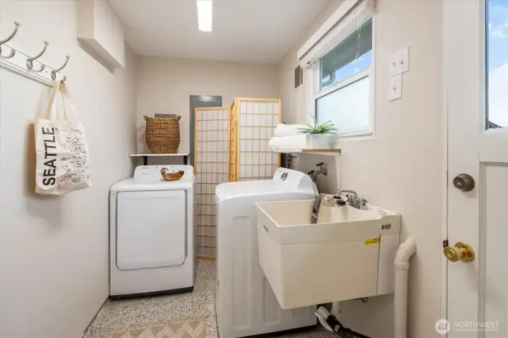 Behind the 2nd living room and bathroom sits the utility room. The door to the right takes you to the fully fenced backyard.