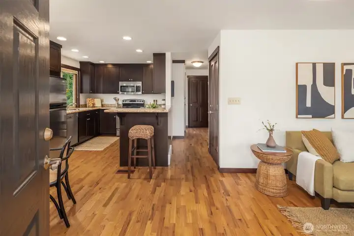 The main floor has an open-plan living/dining/kitchen area, two large bedrooms, and a full bathroom.