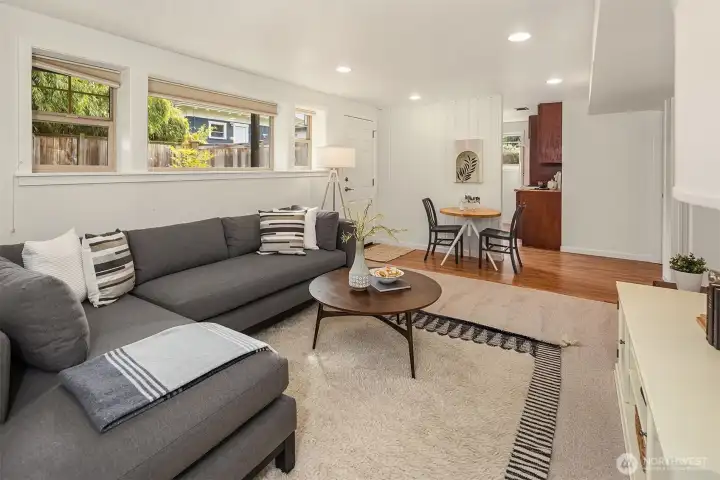 The downstairs living room, looking into the kitchen. The door onto the patio visible in the third photo is the entrance door here.