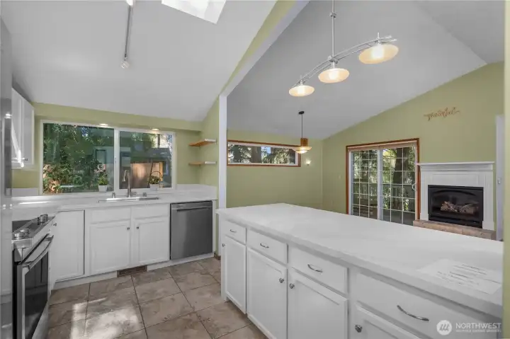 Open kitchen design offers abundant prep space, storage, and connection to the main living area.
