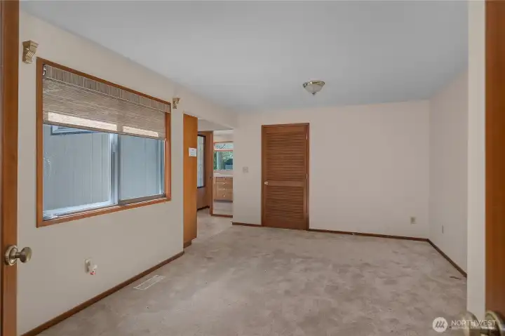 Spacious primary bedroom offers a quiet retreat with direct access to the adjoining bath area.