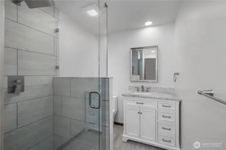 3/4 Hall Bath - NEW - Stylishly updated bath with modern vanity, tiled shower, and clean contemporary finishes.