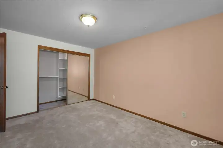 BR 3 - Well-sized bedroom with organized closet space and a bright, simple layout.