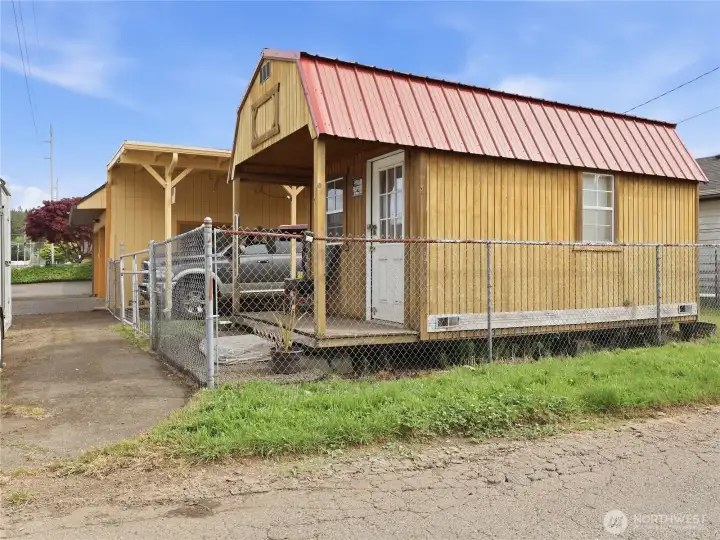 Fully fenced Back Yard has a charming Outbuilding.