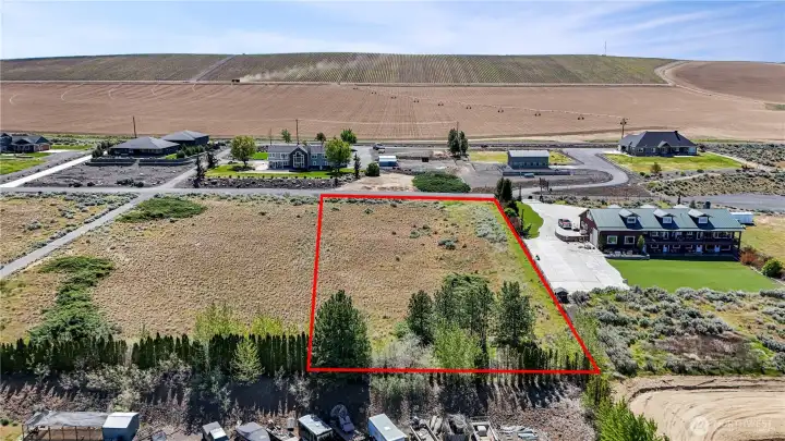 Elevated lot positioning captures expansive reservoir, mountain, and desert landscape views in every direction.