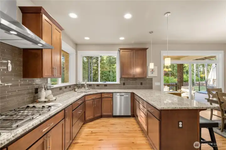Abundant cabinetry, granite counters, generous prep space...