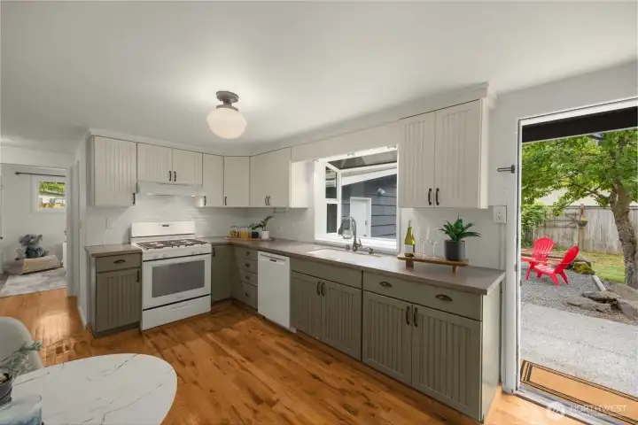 kitchen opens to backyard patio, perfect for entertaining or watching little ones play