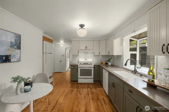 kitchen has hardwood floors, corian counters