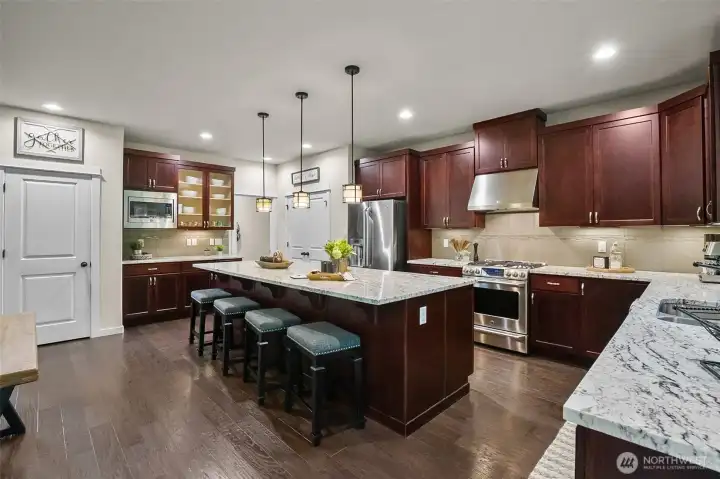 Enormous kitchen appointed with granite and stainless and features 2 pantries. Enormous kitchen appointed with granite and stainless and features 2 pantries.