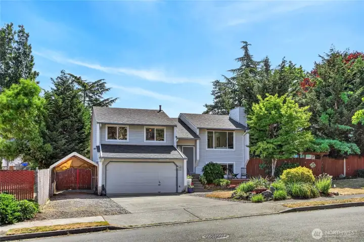 Another view of the front exterior showing all the parking the home has.