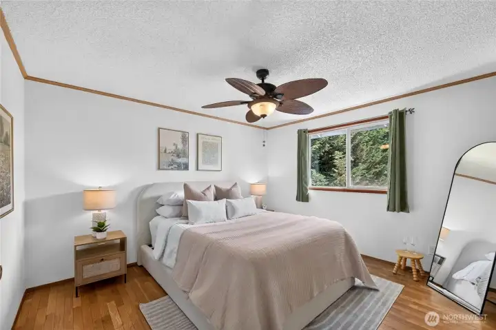 Primary bedroom is comfortable and has direct access to the full bathroom on this level of the home.