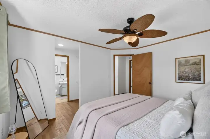 Another view of the primary bedroom, showing the walk-in closet and into the bathroom.