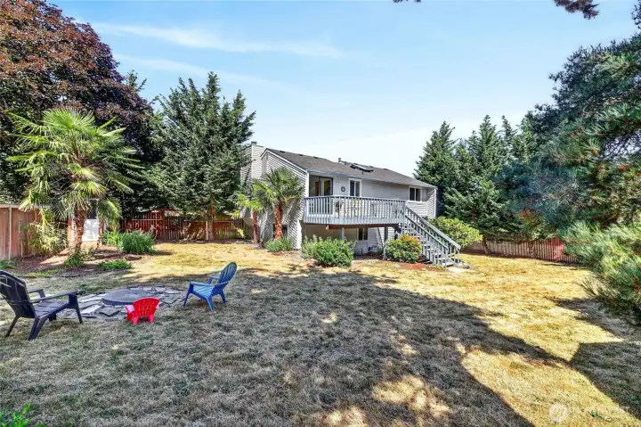 View of the backyard and home from a corner of the yard.  The fire pit on the left has offered a great spot to relax and decompress at the end of a long day.