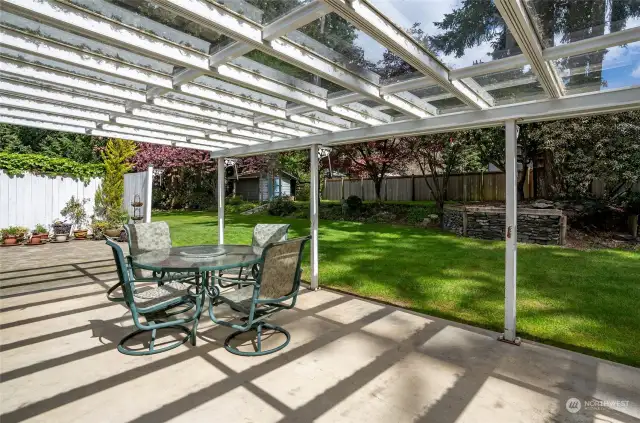 Covered back patio offers a delightful space to enjoy the serene backyard. Perfect for leisurely morning breakfasts or unwinding at the end of a busy day.