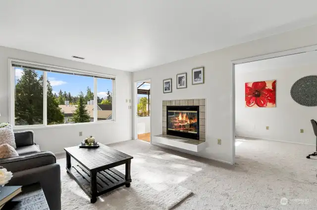 View of the Living Area showing the Fireplace and all the Natural Light flowing in the Windows