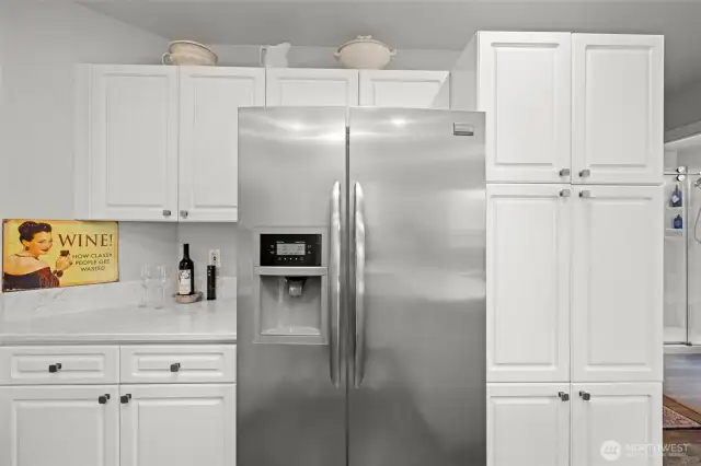 The pantry cabinet is shown to right of the refrigerator.