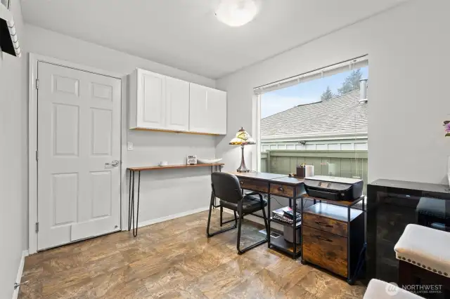 This area can be a kitchen eating space or a home office. The door leads to the garage.