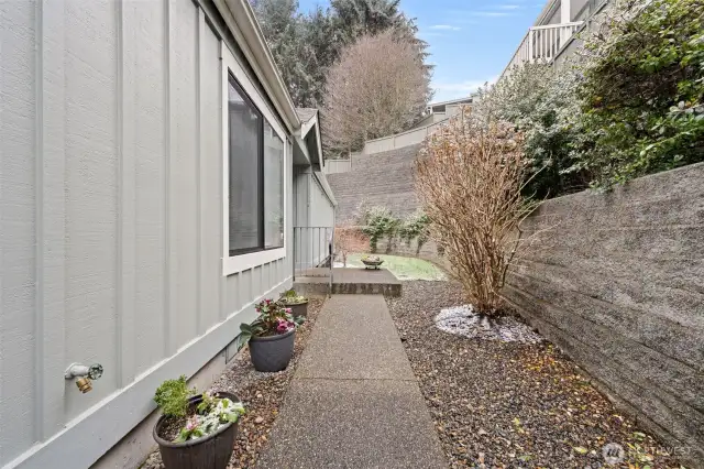 After opening the gate, this walkway leads to the front door entry seen to the left of photo center.