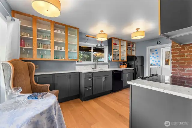 Recently updated kitchen with fabulous quartz counters, contemporary cabinets and new flooring! Kitchen with a vivid personality.