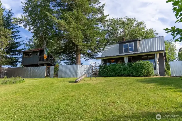 Fenced backyard creates an intimate and private setting with views of distant mountains and hillsides.