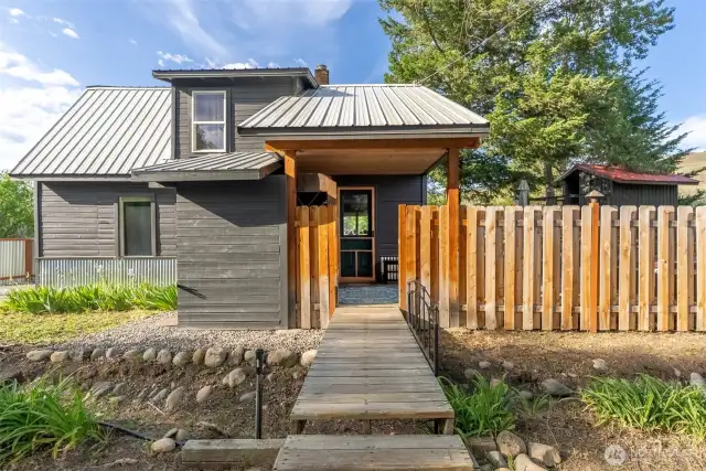 Bridged entry welcomes you to a creative home and setting