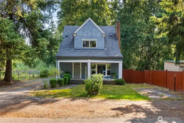 Welcoming front view of the home, featuring a classic covered porch and cottage-style architecture that highlight its timeless character.
