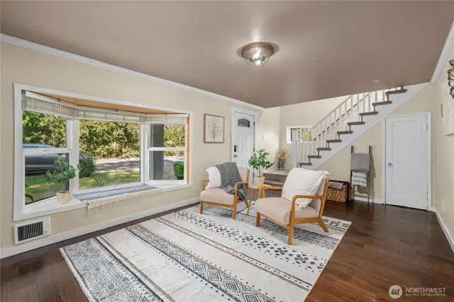 This open layout seamlessly connects the living room to the staircase and entryway, creating a spacious and welcoming flow throughout the home.