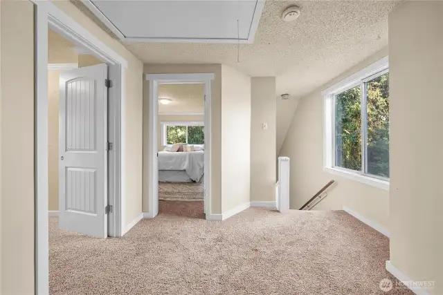 The spacious upstairs landing offers flexibility and function. Large windows fill the space with natural light, while neutral finishes make it easy to customize to your needs.