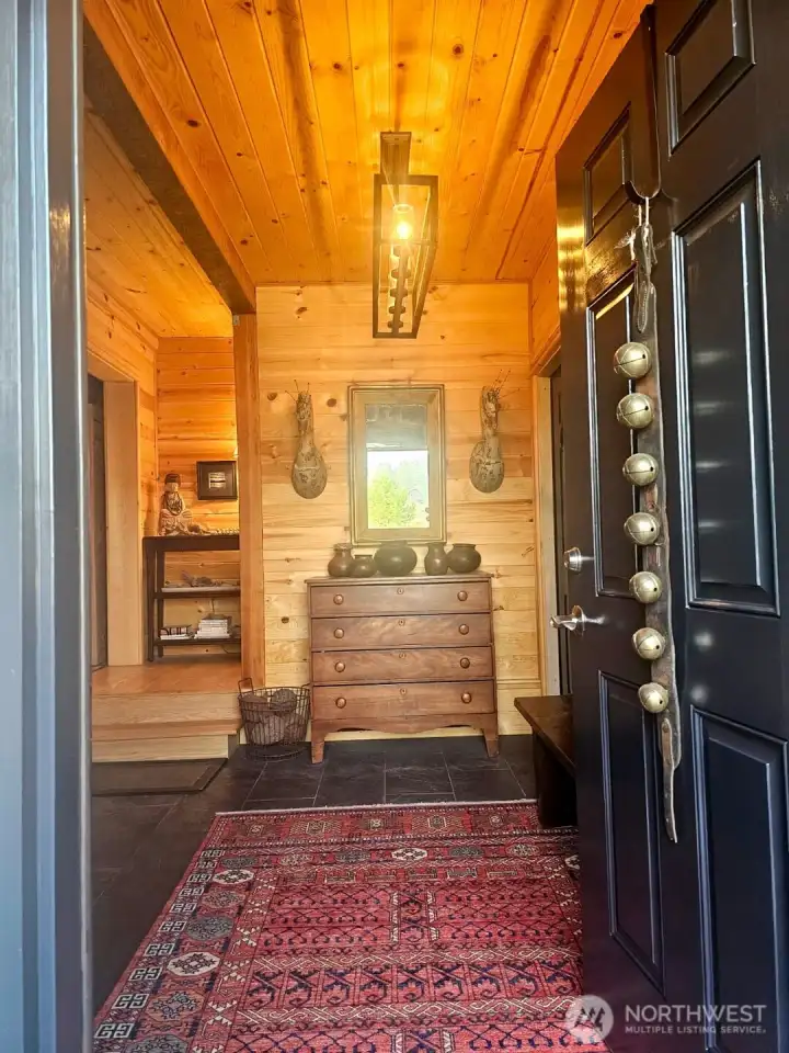 Front door opens to a gracious entry foyer. Bright & beautiful slate floor, deconstructed Coat & Boot closet, Wood bench. Welcoming all family and friends to your home.