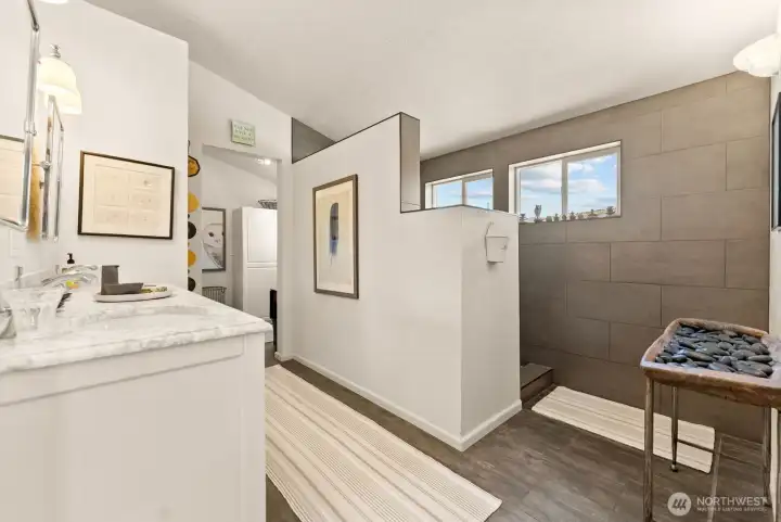 Primary bath ensuite has smooth finishes with beautiful stone and tile features. Laundry room off bath. Walk-in Closet spacious. Double sink vanity.