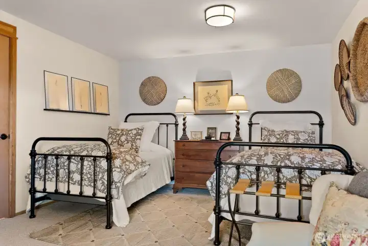 Guest Bedroom 1, daylight basement, ground level, with wood burning fireplace. Covered Outdoor Patio ensuite.