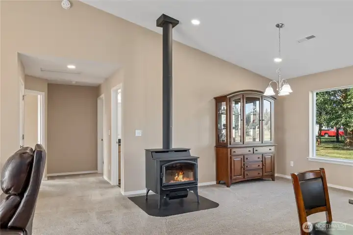 Great room with vaulted ceilings & free standing wood stove.