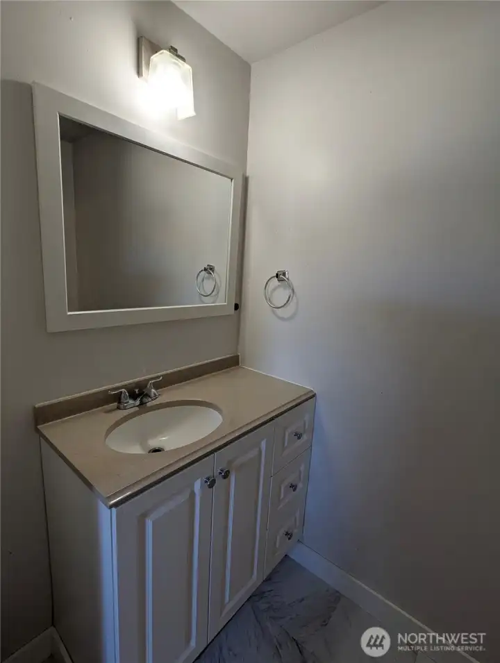 Half bathroom off of the utility room