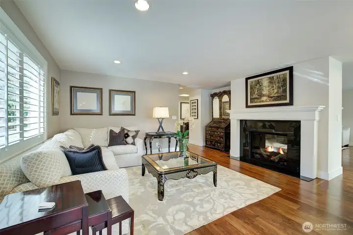 Gorgeous formal living room with two sided fireplace open to family room. Extensive remodel completed in 2020 where almost every surface was touched.