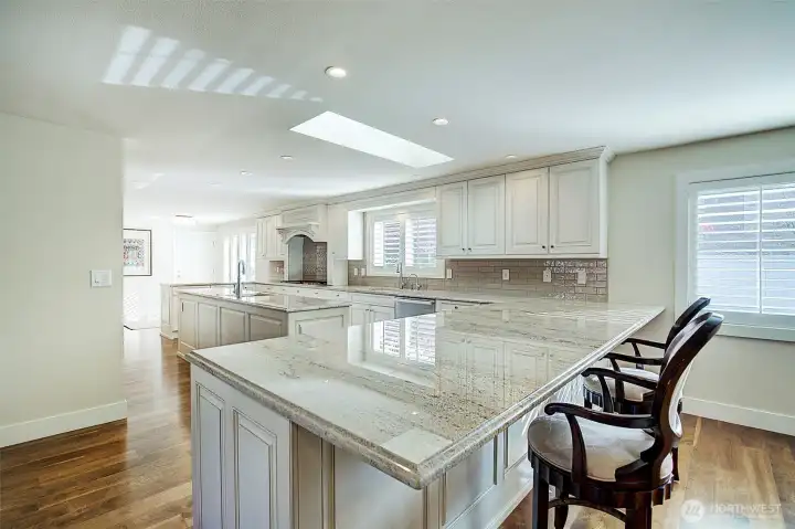 Custom cabinetry in this newly remodeled chef's kitchen! Enjoy the center island with prep sink, unbelievable counter space & granite counters.