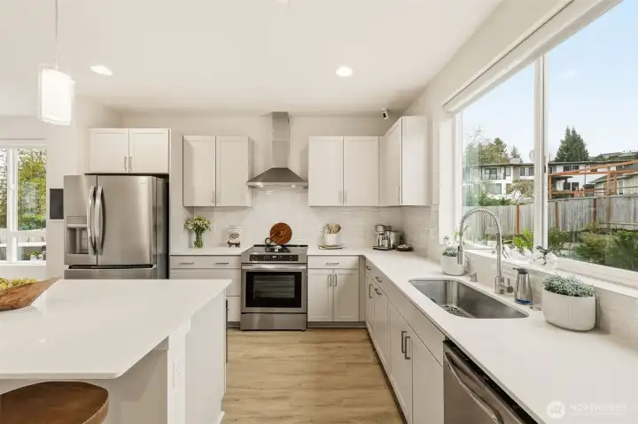 Chef’s kitchen with a quartz island, stainless appliances, and room to gather.