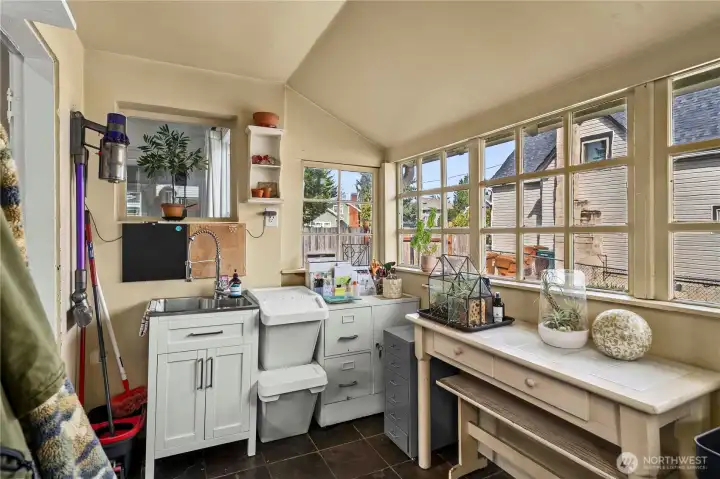 Back enclosed porch for pantry space or a great place to grow herbs just off the kitchen