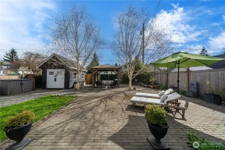 Large backyard with patio and shed