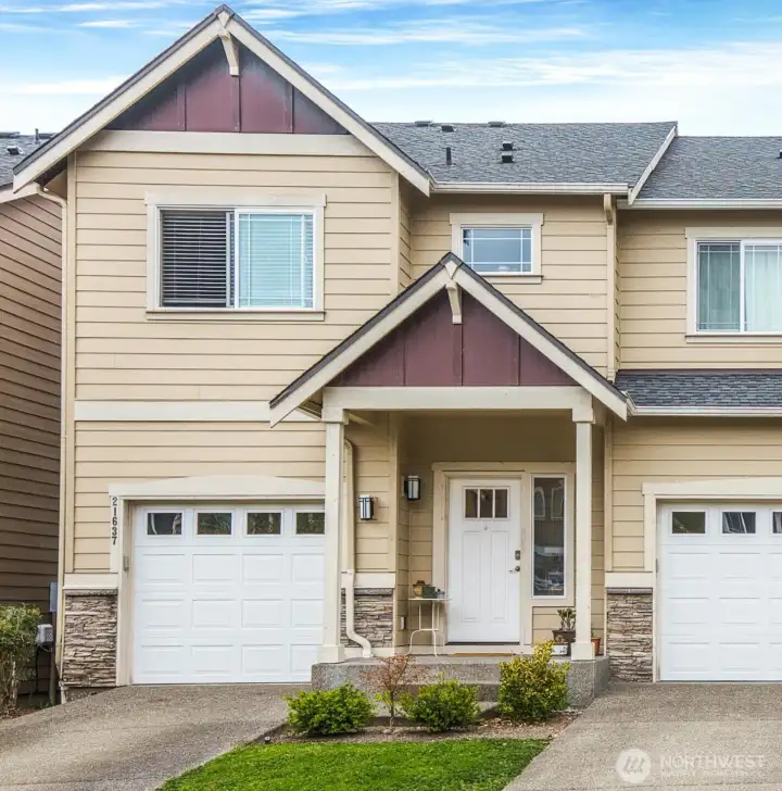 Charming craftsman style townhome. Covered porch and attached garage for extra convenience.