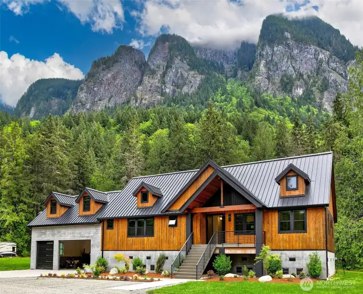 Designed with intent; both the finishes and layout work with the environment; refined but with industrial touches. For the exterior to fit the Pacific Northwest but still stand in contrast with the mountain slab behind it in every season. Exteriors are composed of bright cedar exterior (board and batten, a shade darker than natural) and board form concrete at the base. Top of the line Metal Roof black color, modern black railing, with concrete front porch and stairs. The Exterior Columns in the front and in the back are made with granite slabs; Premium Indian Black Select with a handmade quirk miter detail at every exposed corner. Designed with intent; both the finishes and layout work with the environment; refined but with industrial touches. For the exterior to fit the Pacific Northwest but still stand in contrast with the mountain slab behind it in every season. Exteriors are composed of bright cedar exterior (board and batten, a shade darker than natural) and board form concrete at the base. Top of the line Metal Roof black color, modern black railing, with concrete front porch and stairs. The Exterior Columns in the front and in the back are made with granite slabs; Premium Indian Black Select with a handmade quirk miter detail at every exposed corner.