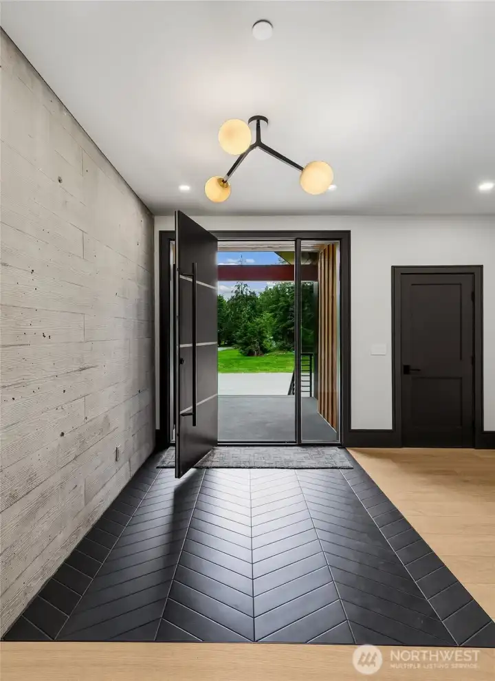 At the entry the board form concrete wall with carries through to the den with that cool black chevron pattern floor. The floors throughout the main level are selected wide plank rift cut and quarter sawn oak (except for bathrooms, entry mentioned above and mud room/laundry room). At the entry the board form concrete wall with carries through to the den with that cool black chevron pattern floor. The floors throughout the main level are selected wide plank rift cut and quarter sawn oak (except for bathrooms, entry mentioned above and mud room/laundry room).