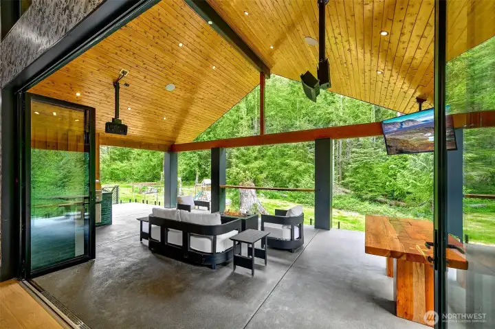 One of my favorite areas is the back patio; The tree of light gate leads to the backyard stairs. The built in kitchen is gorgeous, the green tile and black counters against the cedar are beautiful. Built in BBQ and counters with a little sink and a lot of space right by the window that goes to the dining area to make the space more inclusive for whoever is grilling! There are high quality heating and fans on back patio ceiling and the cedar roof with black lights is just beautiful. One of my favorite areas is the back patio; The tree of light gate leads to the backyard stairs. The built in kitchen is gorgeous, the green tile and black counters against the cedar are beautiful. Built in BBQ and counters with a little sink and a lot of space right by the window that goes to the dining area to make the space more inclusive for whoever is grilling! There are high quality heating and fans on back patio ceiling and the cedar roof with black lights is just beautiful.