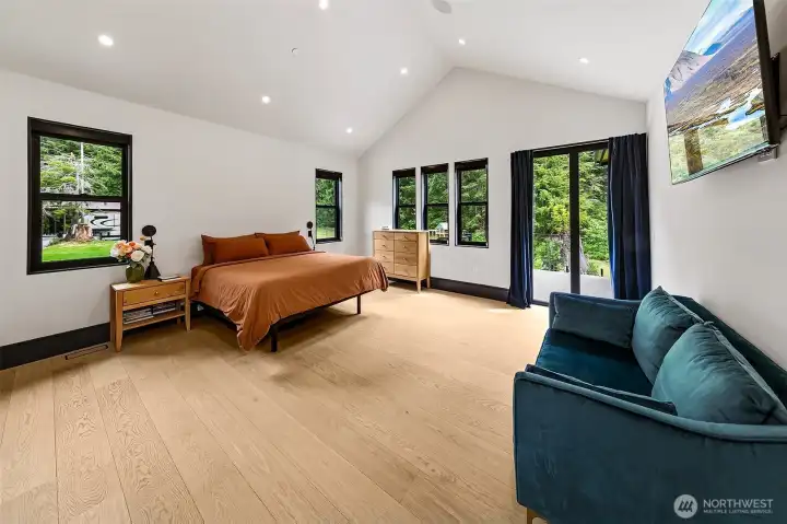 Primary bedroom with small Nano-wall door to the spacious covered deck. Closet is the width of this room on the other side of the primary bath. Primary bedroom with small Nano-wall door to the spacious covered deck. Closet is the width of this room on the other side of the primary bath.