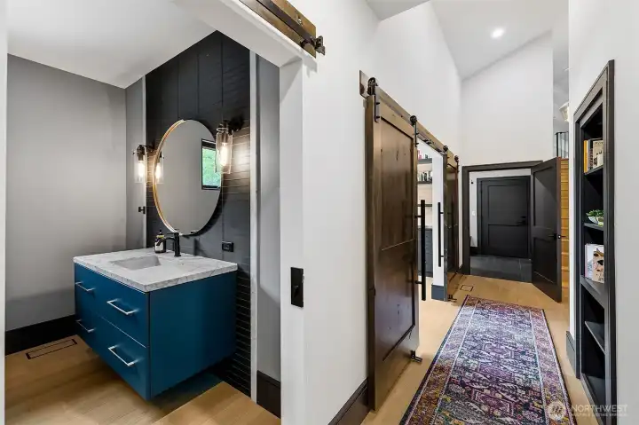 The powder room has Venatino marble countertop and custom square profile to frame the glass tile wall behind the vanity. The best feature of this powder room is that it is large enough to accommodate a seating option, extra storage piece of furniture or a floor set art piece. Hallway to the 2nd office, Mudroom and 3 car attached garage, and upstairs Rec/Family room over garage with vaulted ceilings. The powder room has Venatino marble countertop and custom square profile to frame the glass tile wall behind the vanity. The best feature of this powder room is that it is large enough to accommodate a seating option, extra storage piece of furniture or a floor set art piece. Hallway to the 2nd office, Mudroom and 3 car attached garage, and upstairs Rec/Family room over garage with vaulted ceilings.