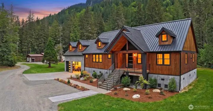 The house was designed with the intent for finishes and layout to work with the environment; refined but with industrial touches. For the exterior to fit the Pacific Northwest but still stand in contrast with the mountain slab behind it in every season. Exteriors are composed of bright cedar exterior (board and batten, a shade darker than natural) and board form concrete at the base. Top of the line Metal Roof black color, modern black railing, with concrete front porch and stairs. The Exterior Columns in the front and in the back are made with granite slabs; Premium Indian Black Select with a handmade quirk miter detail at every exposed corner. The house was designed with the intent for finishes and layout to work with the environment; refined but with industrial touches. For the exterior to fit the Pacific Northwest but still stand in contrast with the mountain slab behind it in every season. Exteriors are composed of bright cedar exterior (board and batten, a shade darker than natural) and board form concrete at the base. Top of the line Metal Roof black color, modern black railing, with concrete front porch and stairs. The Exterior Columns in the front and in the back are made with granite slabs; Premium Indian Black Select with a handmade quirk miter detail at every exposed corner.