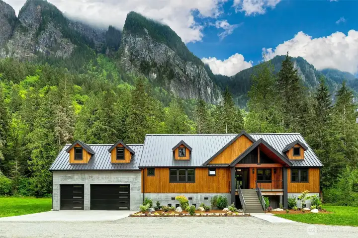 The house was designed with the intent for finishes and layout to work with the environment; refined but with industrial touches. For the exterior to fit the Pacific Northwest but still stand in contrast with the mountain slab behind it in every season. Exteriors are composed of bright cedar exterior (board and batten, a shade darker than natural) and board form concrete at the base. Top of the line Metal Roof black color, modern black railing, with concrete front porch and stairs. The Exterior Columns in the front and in the back are made with granite slabs; Premium Indian Black Select with a handmade quirk miter detail at every exposed corner. The house was designed with the intent for finishes and layout to work with the environment; refined but with industrial touches. For the exterior to fit the Pacific Northwest but still stand in contrast with the mountain slab behind it in every season. Exteriors are composed of bright cedar exterior (board and batten, a shade darker than natural) and board form concrete at the base. Top of the line Metal Roof black color, modern black railing, with concrete front porch and stairs. The Exterior Columns in the front and in the back are made with granite slabs; Premium Indian Black Select with a handmade quirk miter detail at every exposed corner.