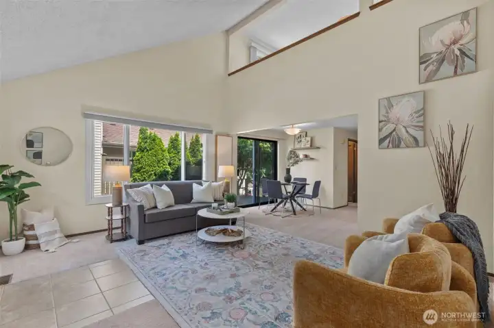 Brand new carpet throughout and a cozy fireplace create a warm and inviting atmosphere in the airy living room with vaulted ceilings. Brand new carpet throughout and a cozy fireplace create a warm and inviting atmosphere in the airy living room with vaulted ceilings.