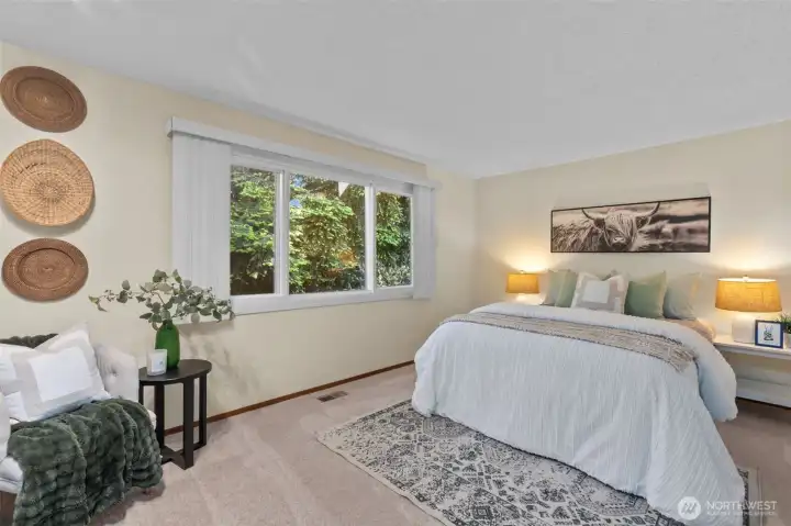 Spacious primary bedroom on main level. Spacious primary bedroom on main level.