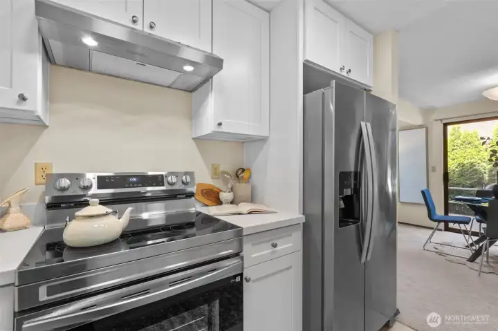 Updated kitchen with quartz countertops, shaker cabinets, and stainless appliances, including new stove and dishwasher. Updated kitchen with quartz countertops, shaker cabinets, and stainless appliances, including new stove and dishwasher.